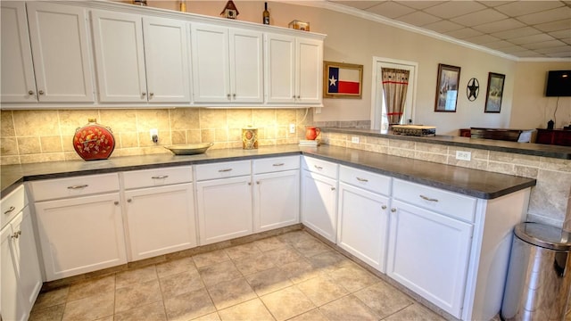 kitchen featuring kitchen peninsula and white cabinets