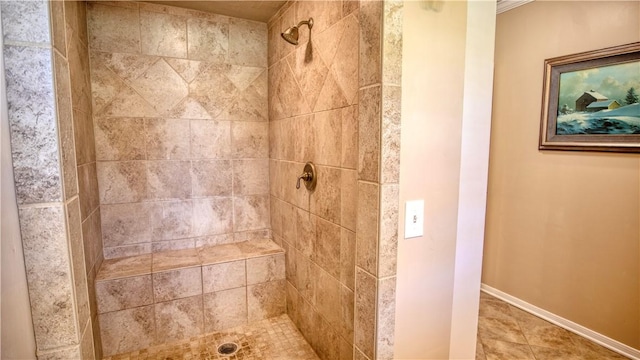 bathroom featuring ornamental molding, a tile shower, and tile patterned floors