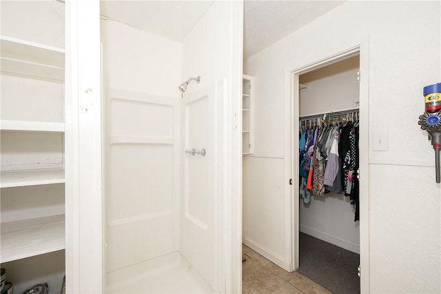 202 S Broadway St, Caldwell, TX 77836 - bathroom featuring a shower stall and a spacious closet