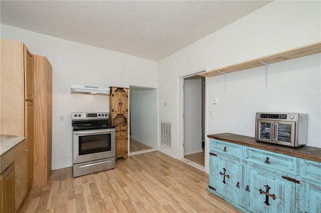 202 S Broadway St, Caldwell, TX 77836 - kitchen featuring electric stove, under cabinet range hood, and light wood-type flooring