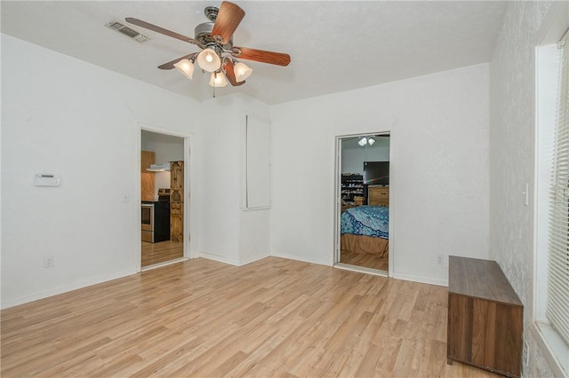 202 S Broadway St, Caldwell, TX 77836 - empty room with ceiling fan and light wood-style floors