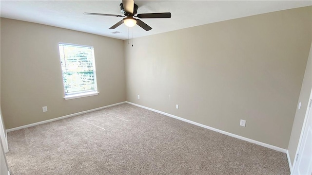 unfurnished room with ceiling fan and light carpet