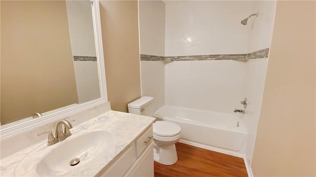 full bathroom featuring hardwood / wood-style flooring, vanity, toilet, and tiled shower / bath combo