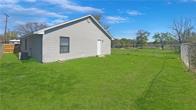 view of side of home featuring a lawn and central air condition unit