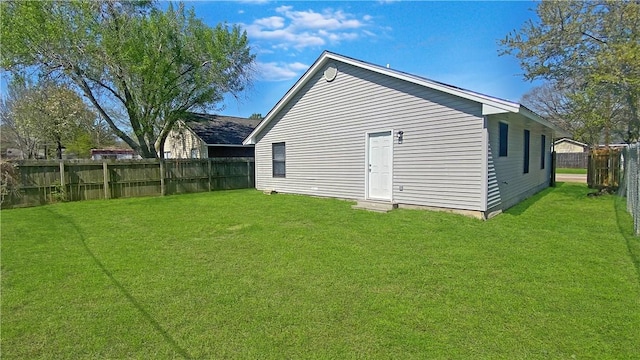 back of house with a lawn