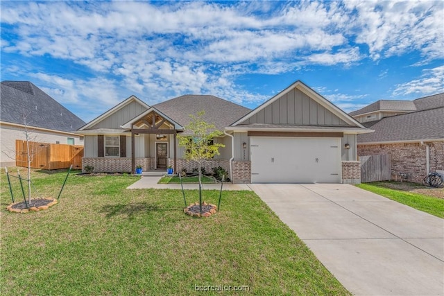 craftsman inspired home with a garage and a front lawn