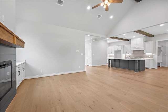 13291 Hopes Creek Rd, College Station, TX 77845 - unfurnished living room featuring ceiling fan, high vaulted ceiling, light wood-type flooring, baseboards, and recessed lighting