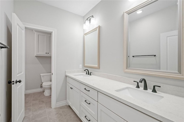 13291 Hopes Creek Rd, College Station, TX 77845 - full bathroom featuring toilet, double vanity, and baseboards