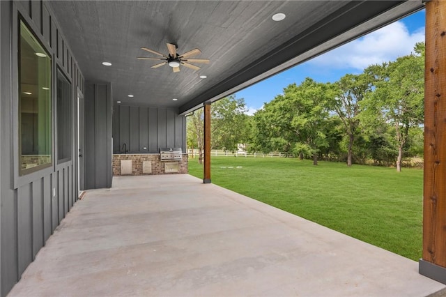 13291 Hopes Creek Rd, College Station, TX 77845 - view of patio / terrace featuring an outdoor kitchen, ceiling fan, grilling area, and view of scattered trees