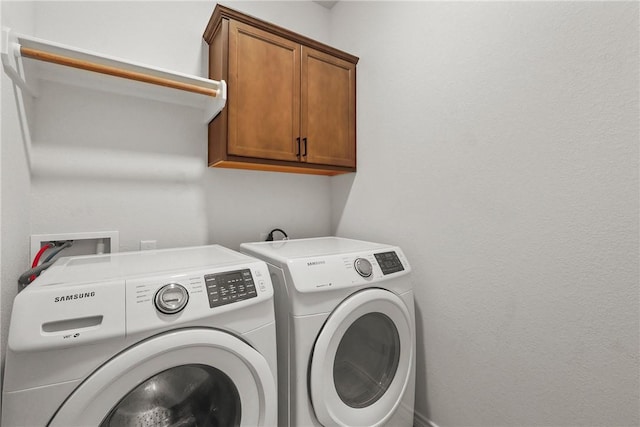 3448 Pointe Du Hoc Dr, Bryan, TX 77808 - washroom featuring cabinet space and washing machine and dryer