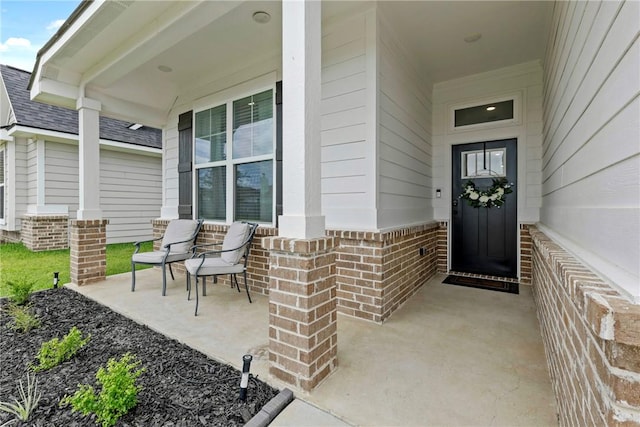 3448 Pointe Du Hoc Dr, Bryan, TX 77808 - property entrance with covered porch, brick siding, and a shingled roof