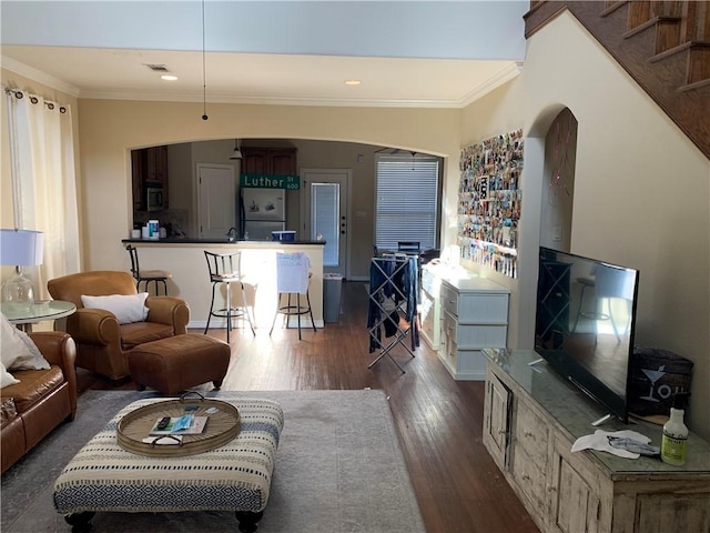 living room with ornamental molding and dark wood-type flooring