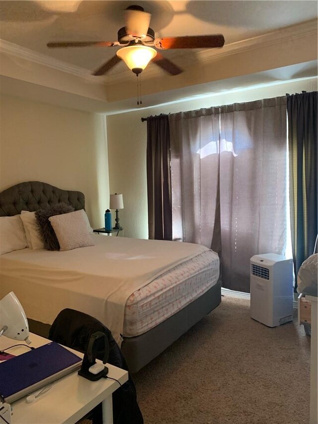 carpeted bedroom featuring ceiling fan and crown molding