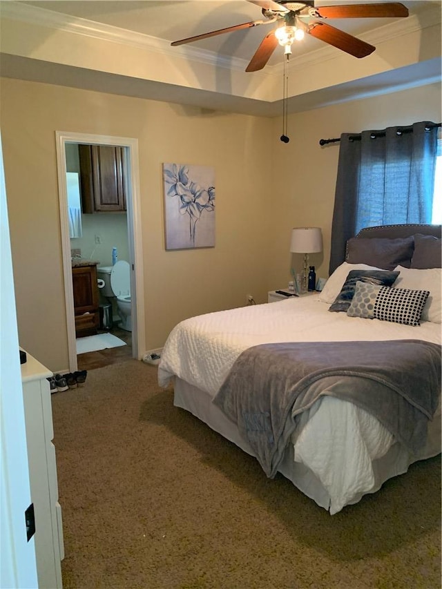 carpeted bedroom with a raised ceiling, ceiling fan, and crown molding