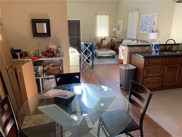 dining area with light hardwood / wood-style flooring and sink