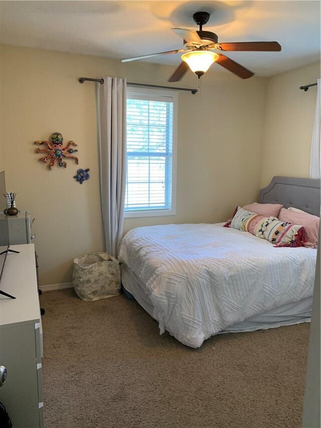 carpeted bedroom featuring ceiling fan