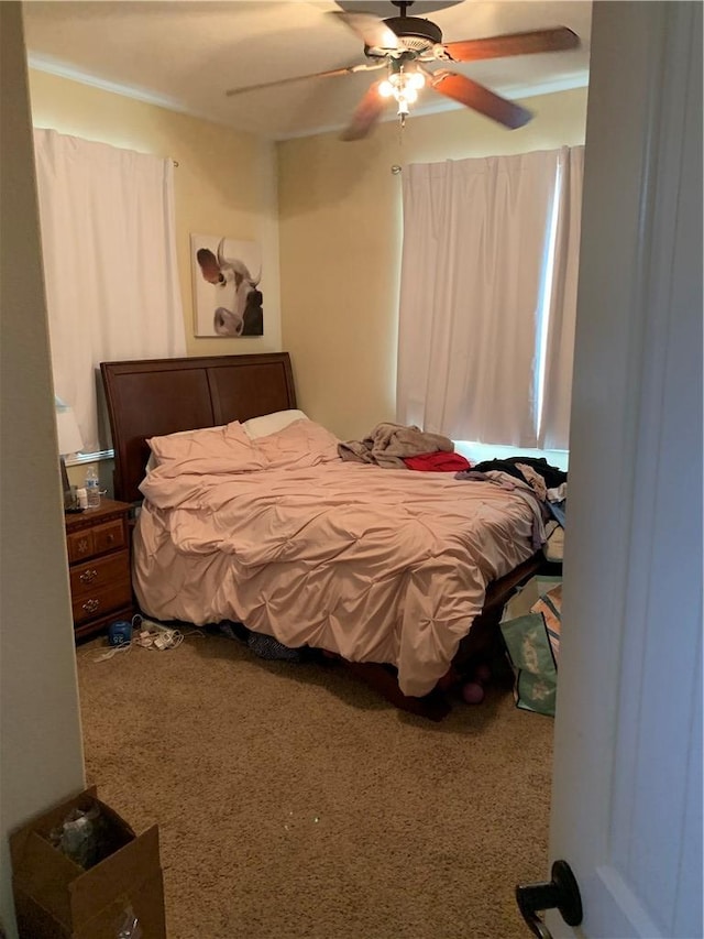 carpeted bedroom with ceiling fan