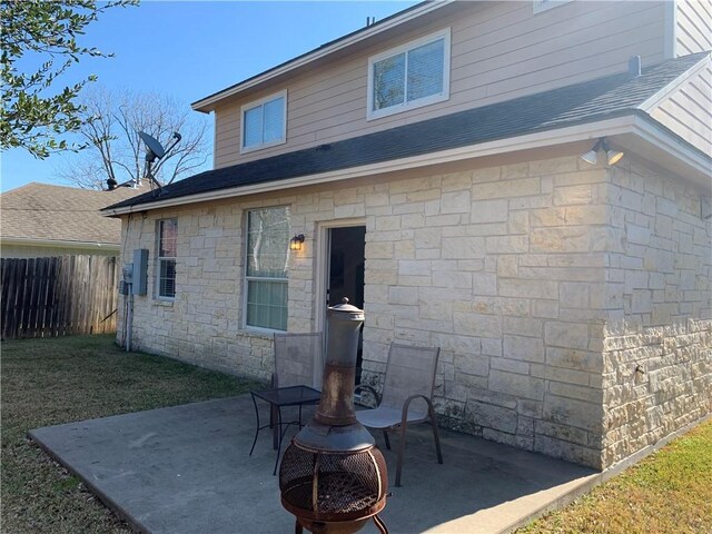 back of property featuring a patio area and an outdoor fire pit