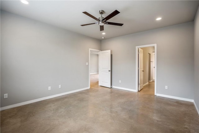 unfurnished bedroom featuring ceiling fan, concrete flooring, and ensuite bath