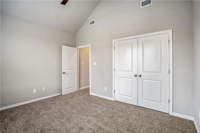 unfurnished bedroom with carpet floors, high vaulted ceiling, and a closet