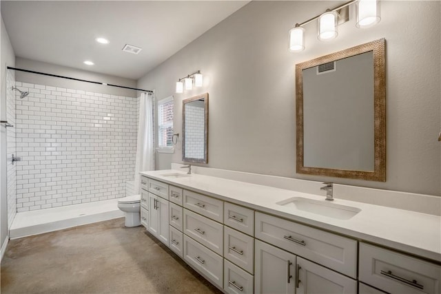 bathroom featuring vanity, toilet, and walk in shower