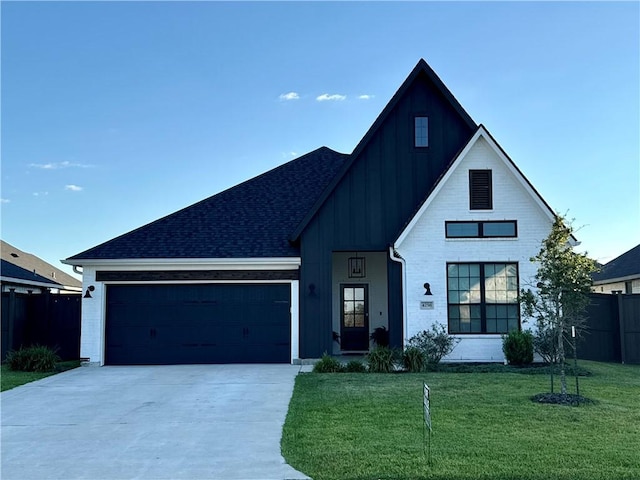 modern inspired farmhouse with a garage and a front lawn