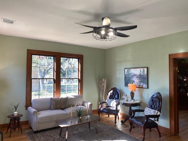 living room featuring ceiling fan and hardwood / wood-style floors