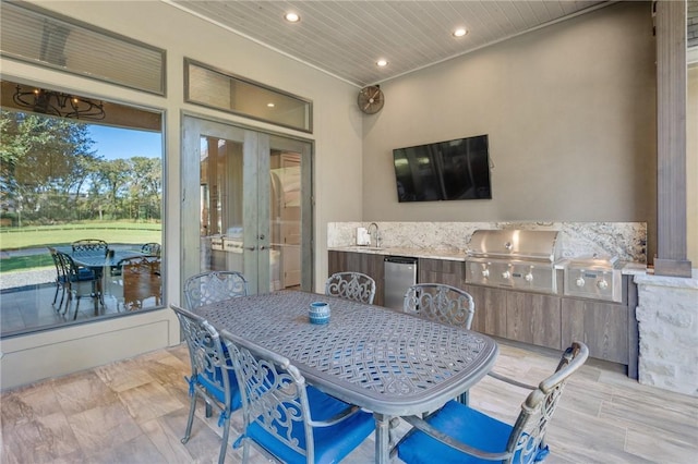 view of patio featuring sink, a grill, and exterior kitchen