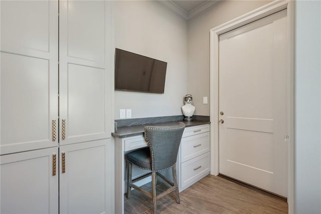 office area featuring ornamental molding and light wood-type flooring