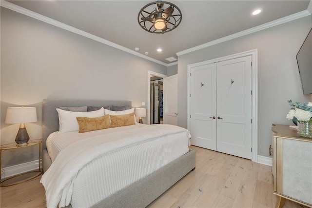 bedroom featuring a closet, light hardwood / wood-style floors, and ornamental molding