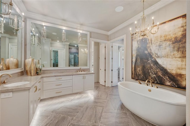 bathroom featuring a tub, vanity, a chandelier, and ornamental molding