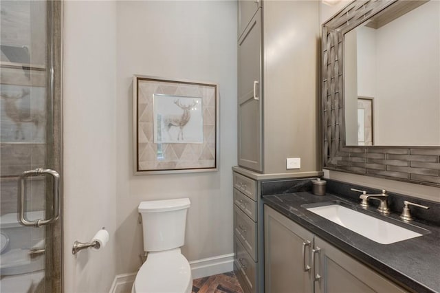 bathroom with vanity, an enclosed shower, and toilet