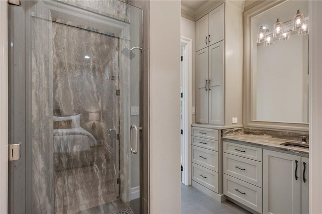 bathroom featuring crown molding, vanity, and an enclosed shower