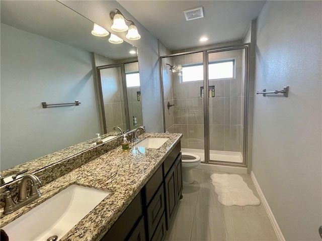 full bathroom with visible vents, a sink, a shower stall, and toilet