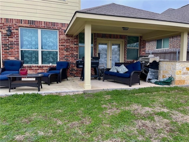 view of patio with grilling area, fence, outdoor lounge area, and french doors