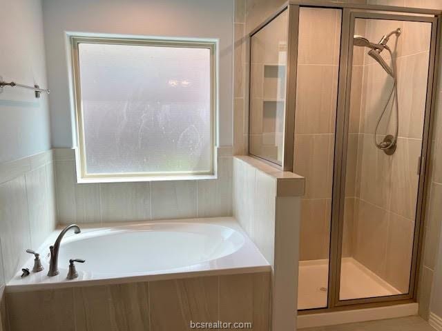 bathroom with a garden tub and a shower stall