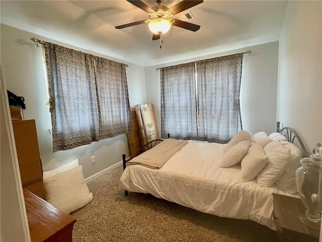 carpeted bedroom featuring ceiling fan and baseboards