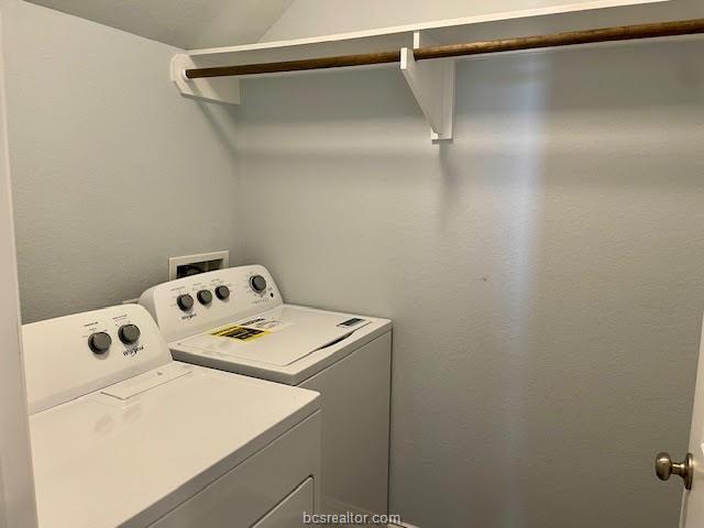 washroom with washing machine and dryer and laundry area