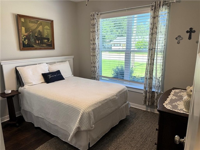202 N Hearne St, Franklin, TX 77856 - bedroom with baseboards, multiple windows, and dark wood finished floors