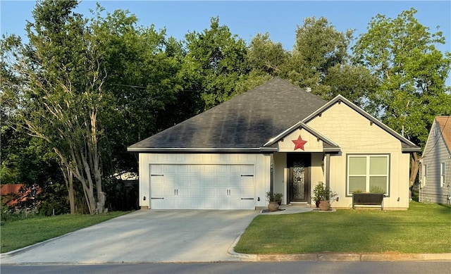 202 N Hearne St, Franklin, TX 77856 - view of front facade featuring concrete driveway, roof with shingles, a garage, and a front lawn