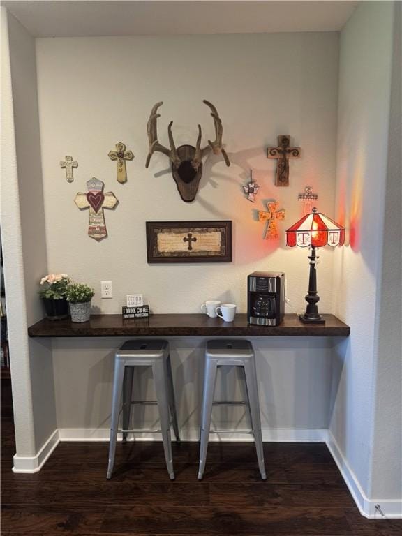 202 N Hearne St, Franklin, TX 77856 - bar with baseboards and dark wood finished floors