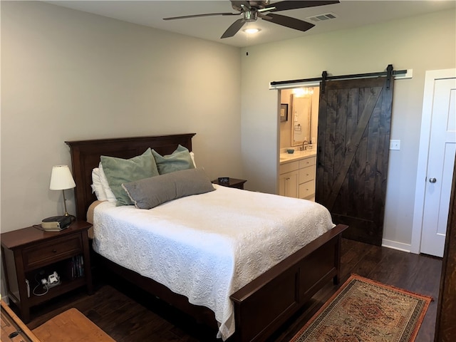 202 N Hearne St, Franklin, TX 77856 - bedroom featuring a ceiling fan, dark wood-type flooring, a barn door, visible vents, and ensuite bath