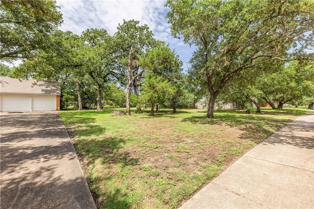 1500 Galde St, College Station, TX 77840 - view of grassy yard featuring a garage