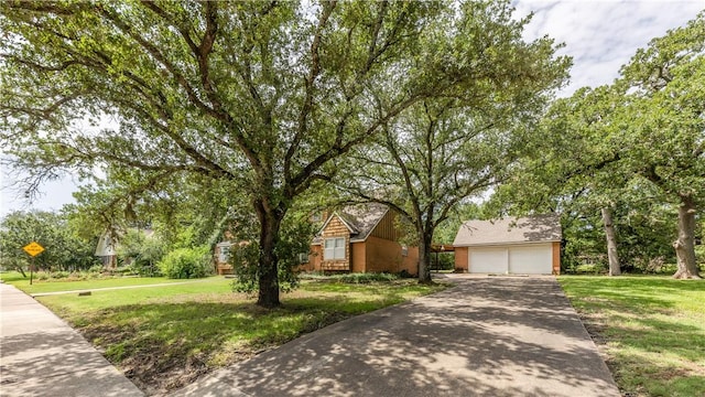 1500 Galde St, College Station, TX 77840 - obstructed view of property featuring a garage, a front lawn, concrete driveway, and an outbuilding