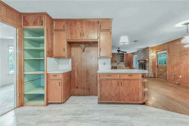 1500 Galde St, College Station, TX 77840 - kitchen with wood walls, light countertops, a peninsula, open shelves, and a fireplace