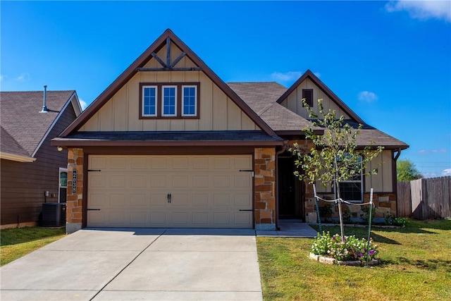 view of front of property with a garage, cooling unit, and a front yard