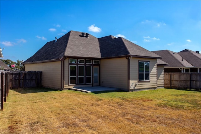 back of house featuring a fenced backyard, a lawn, and a patio