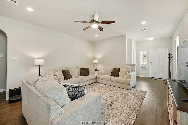 living room with dark hardwood / wood-style floors and ceiling fan