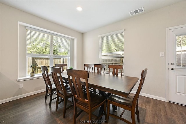 dining room with dark hardwood / wood-style flooring