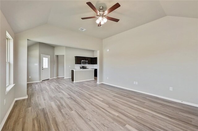 unfurnished living room featuring vaulted ceiling, ceiling fan, and light wood-type flooring